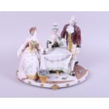 A Continental figure group, playing cards, 9" high (damages)
