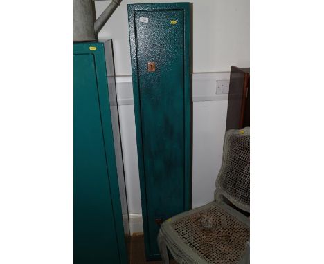A green painted metal gun cabinet with keys, 11" wide