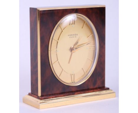 An Hermes "tortoiseshell" alarm clock with gilt dial and Roman numerals, 3" high