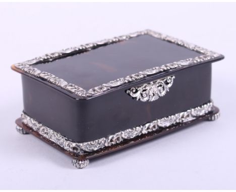 A rectangular tortoiseshell trinket box with embossed silver mounts and bun feet, by John Batson & Son, London 1916,4 1/4" wi