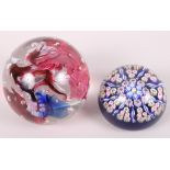 Two glass paperweights, one with "inka" etched to base