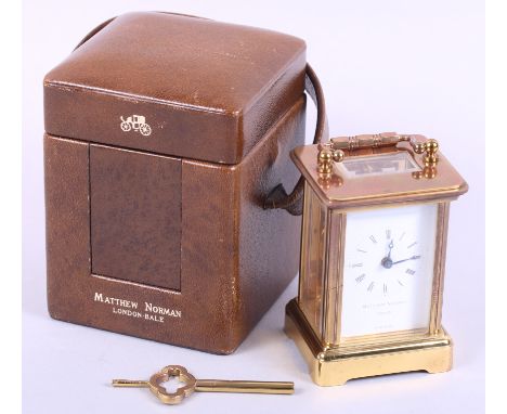 A Matthew Norman carriage clock with white enamel dial and Roman numerals, in leather case, 3 1/4" high