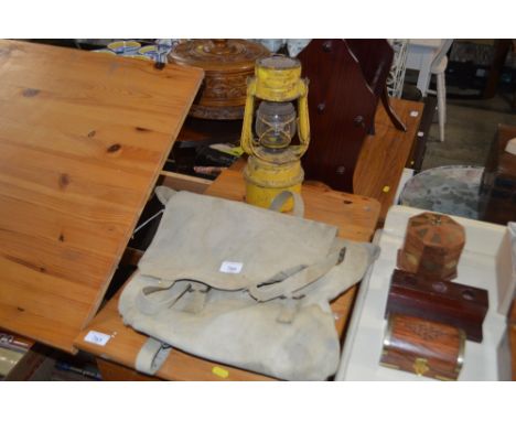 A hurricane lamp and a canvas bag