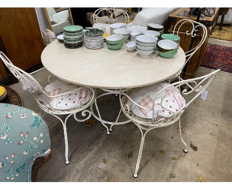 A circular reconstituted marble garden table, diameter 120cm, height 74cm and four painted wrought iron chairs