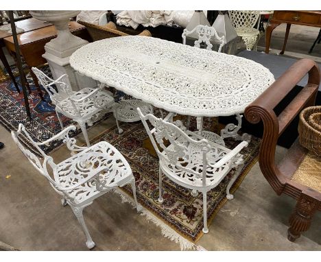 A Victorian style painted cast aluminium garden table, length 180cm, width 90cm, height 72cm and four matching elbow chairs