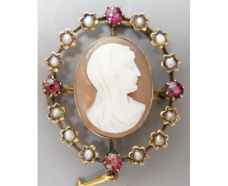 An Edwardian yellow metal, split pearl and ruby mounted oval cameo shell pendant brooch, 32mm, gross weight 6 grams.