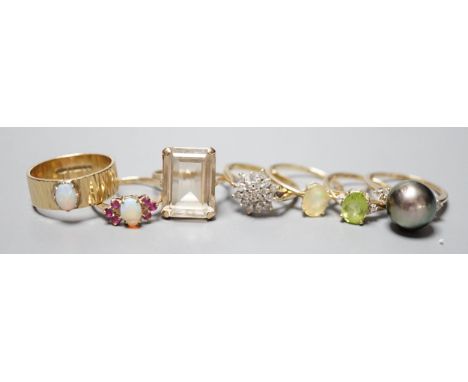 Seven assorted modern 9ct gold and gem set dress rings, including diamond cluster, white opal and white opal and ruby cluster