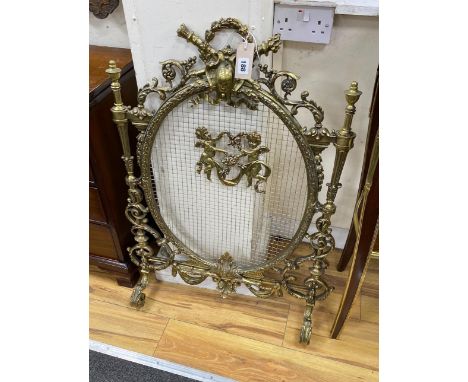 A Victorian style cast brass mesh fireguard, height 87cm.