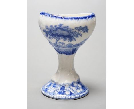 A Spode blue and white transfer printed pottery eye bath, early 19th century decorated with a landscape, marked Spode to base