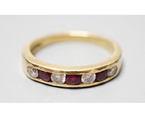 A modern 18ct gold and channel set four stone diamond and three stone ruby set half hoop ring, size N, gross weight 4.3 grams