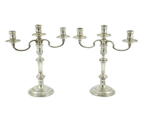 A modern pair of silver two branch, three light candelabra by William Comyns &amp; Sons Ltd, height 35.3cm, weighted.
