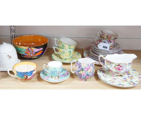 A Clarice Cliff tea cup, a collection of chintz patterned teaware, a lustre bowl and a honey pot and cover