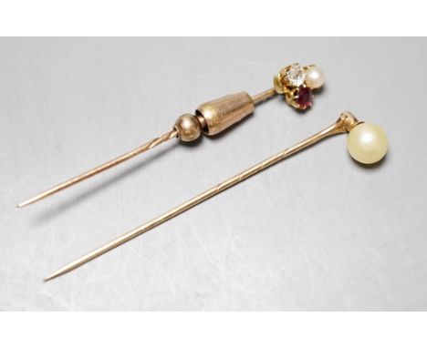 An early 20th century yellow metal, ruby, diamond and cultured pearl cluster set stick pin, 58mm and a yellow metal and simul