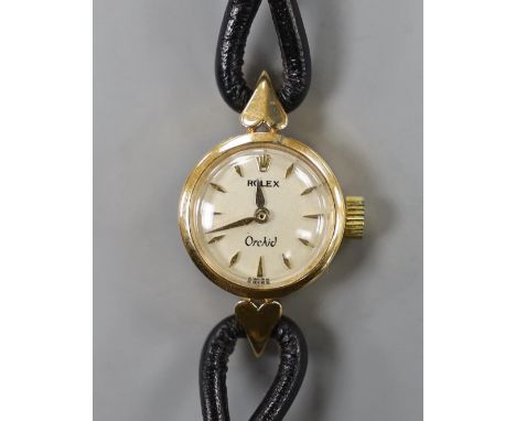 A lady's mid 20th century 750 yellow metal Rolex Orchid manual wind wrist watch, with engraved inscription, on associated lea