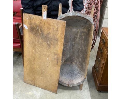 A chip carved grain trough, length 104cm and a provincial wood board, length 102cm