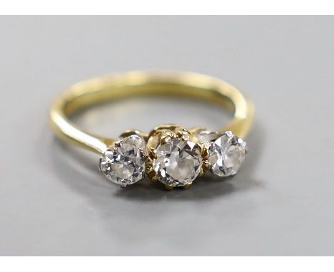 A modern 18ct gold and three stone set diamond ring, size K/L, gross weight 3 grams.