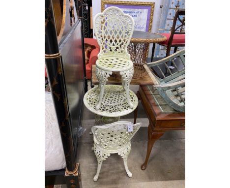 A Victorian style painted aluminum circular garden table, diameter 64cm, height 66cm and two matching armchairs