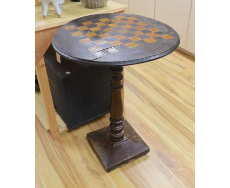 A stained pine inlaid chessboard top table, 75cm high, 56cm diameter and a set of Staunton chess pieces