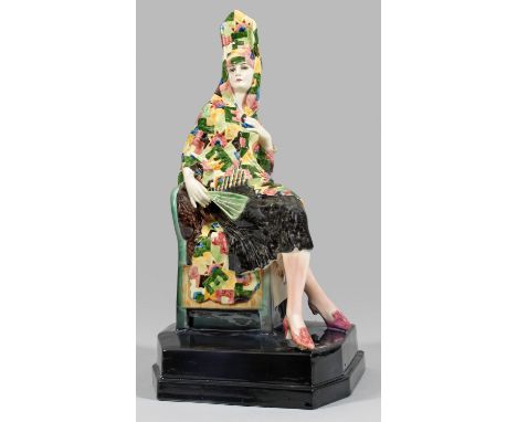 Art Déco-Figur "Carmen". Originaltitel Steingut. Unregelmäßiger, profilgerahmter Sockel. Auf einem Stuhl, mit übereinander ge