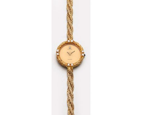 Sarcar-Damenarmbanduhr aus den 90er Jahren Gelbgold, gest. 750. Rundes Uhrengehäuse,umzogen von doppeltem Kordelband, besetzt