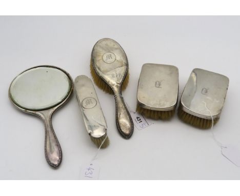 Assorted silver vanity set items, including a hand mirror and hair brush by J &amp; R Griffin, Chester 1922, three clothes br