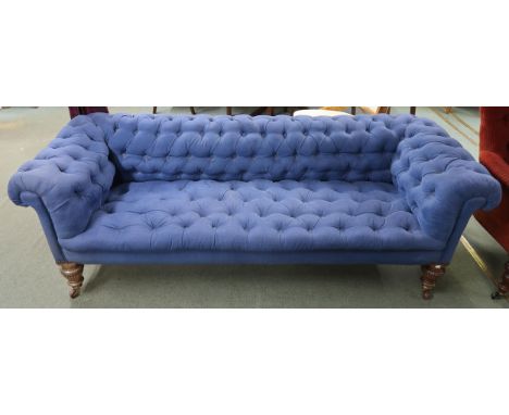 A Victorian button back club style settee on turned rosewood supports, 68cm high x 208cm wide x 81cm deep Condition Report:Av