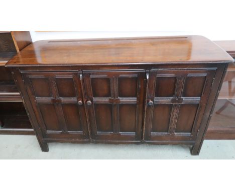 A mid 20th century Ercol elm and beech "old colonial" three door sideboard, 89cm high x 145cm wide x 50cm deep Condition Repo