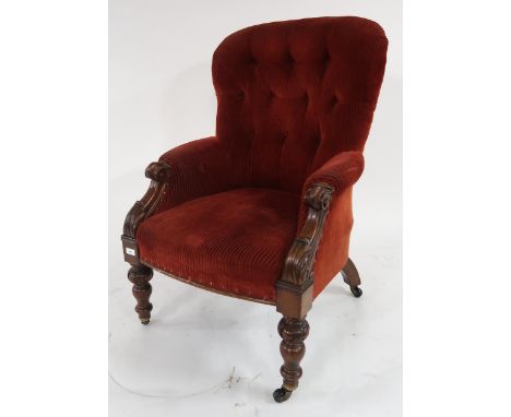 A Victorian button back armchair with turned front supports Condition Report:Available upon request