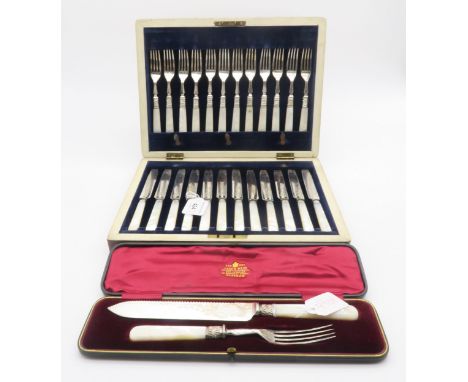 A cased set of silver collared, EPNS bladed and mother of pearl handled fruit knives and forks, the knives with engraved scro