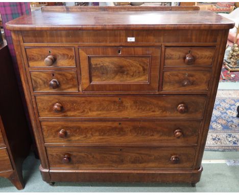 A Victorian mahogany scotch chest with four asymmetrical drawers above three long drawers on casters, 126cm high x 125cm wide