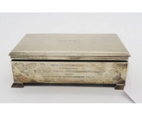 A silver tobacco box / humidor, the body with engine turned decoration surrounding a monogrammed rectangular cartouche, the f