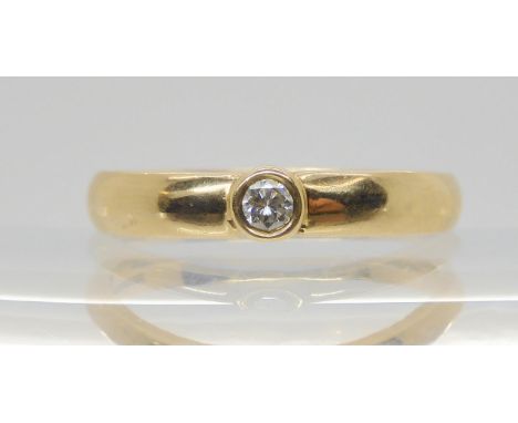 A 9ct gold band ring set with a 0.10ct brilliant cut diamond, size R, weight 3gms Condition Report:Available upon request