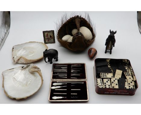 A tray lot comprising an armadillo basket, spelter wild boar novelty thermometer, ostrich eggs, oyster shells dominoes set et