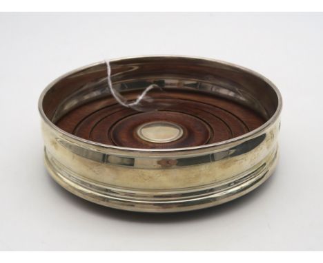 A boxed silver wine coaster, with turned wooden base and a blank circular cartouche, by Mappin &amp; Webb, Birmingham 2000 Co