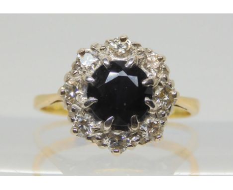 A yellow and white metal sapphire and diamond ring, set with estimated approx 0.25cts of brilliant cut diamonds, size K, weig