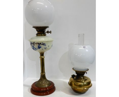 A Victorian oil lamp with painted glass reservoir and another smaller lamp Condition Report:Available upon request