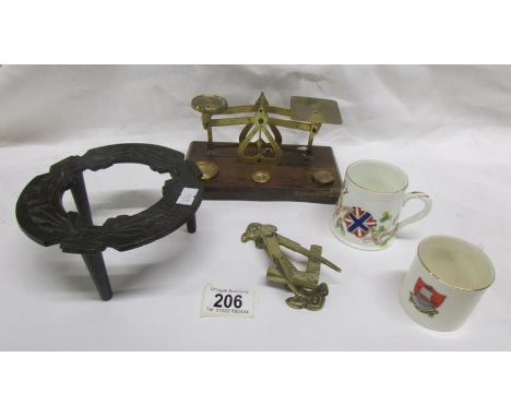 A brass postal scale, a cast iron trivet, a brass Masonic themed door knocker and 2 commemorative cups