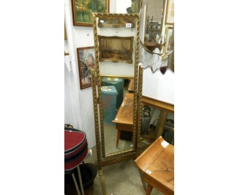 A gilt framed cheval mirror