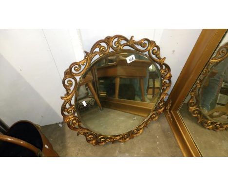 A gilt framed wall mirror