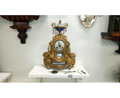 A French gilt mantel clock with enamel dial