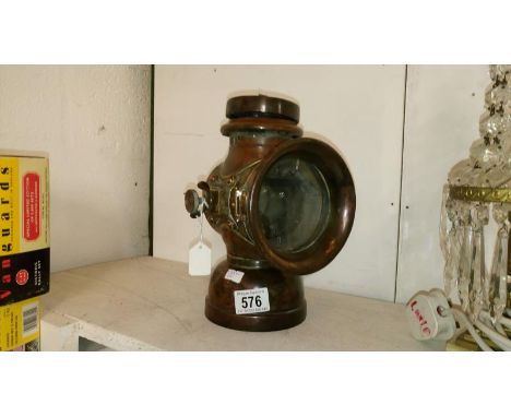An early 20th century King of the Road car lamp marked Belsize (handle missing and crack to glass)
