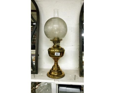 A brass oil lamp with Victorian acid etched shade