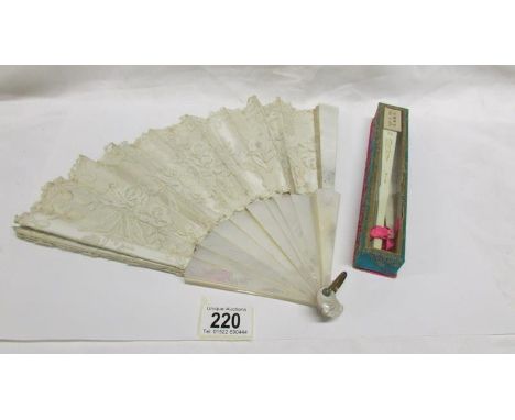 A beautiful early 20th century silk and mother of pearl fan embroidered with flowers and an a/f bone fan