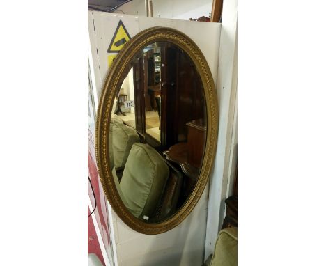 A Victorian/Edwardian oval gilt framed bevel edged mirror