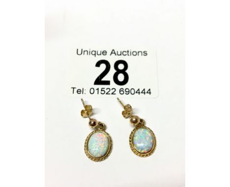 A pair of yellow gold opal earrings