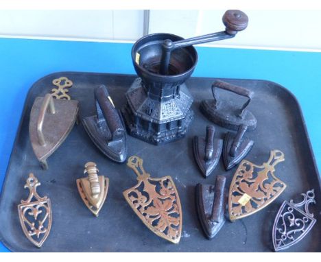 Seven flat irons and five trivets and an A.K and sons cast iron coffee grinder Condition reports cannot be done for our Inter