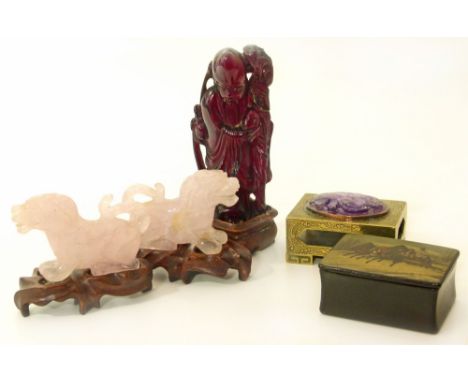 A pair of rose quartz Chinese dragons on wooden bases, a small brass box inset with amethyst amulet, Chinese resin figure on 