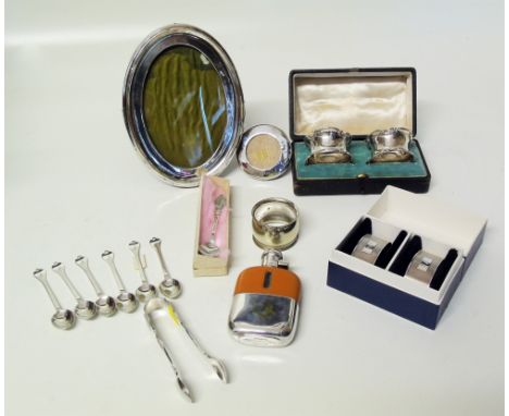 Two pairs of silver napkin rings (boxed) a set of six silver teaspoons and sugar tongs, two silver frames and a plated small 