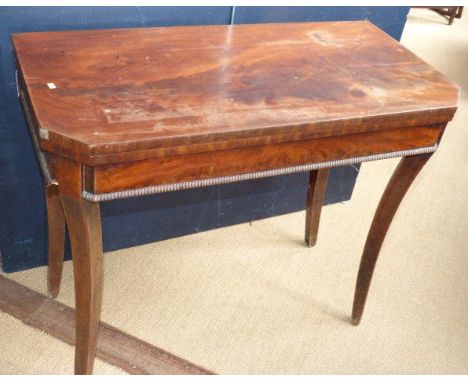 A 19th century mahogany fold over card table with green beige top on sabre legs 92 x 45cm Condition reports cannot be done fo