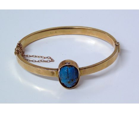 9ct gold bangle with rotating turquoise charm, one half carved as a scarab beetle, the other engraved with a scorpion Conditi